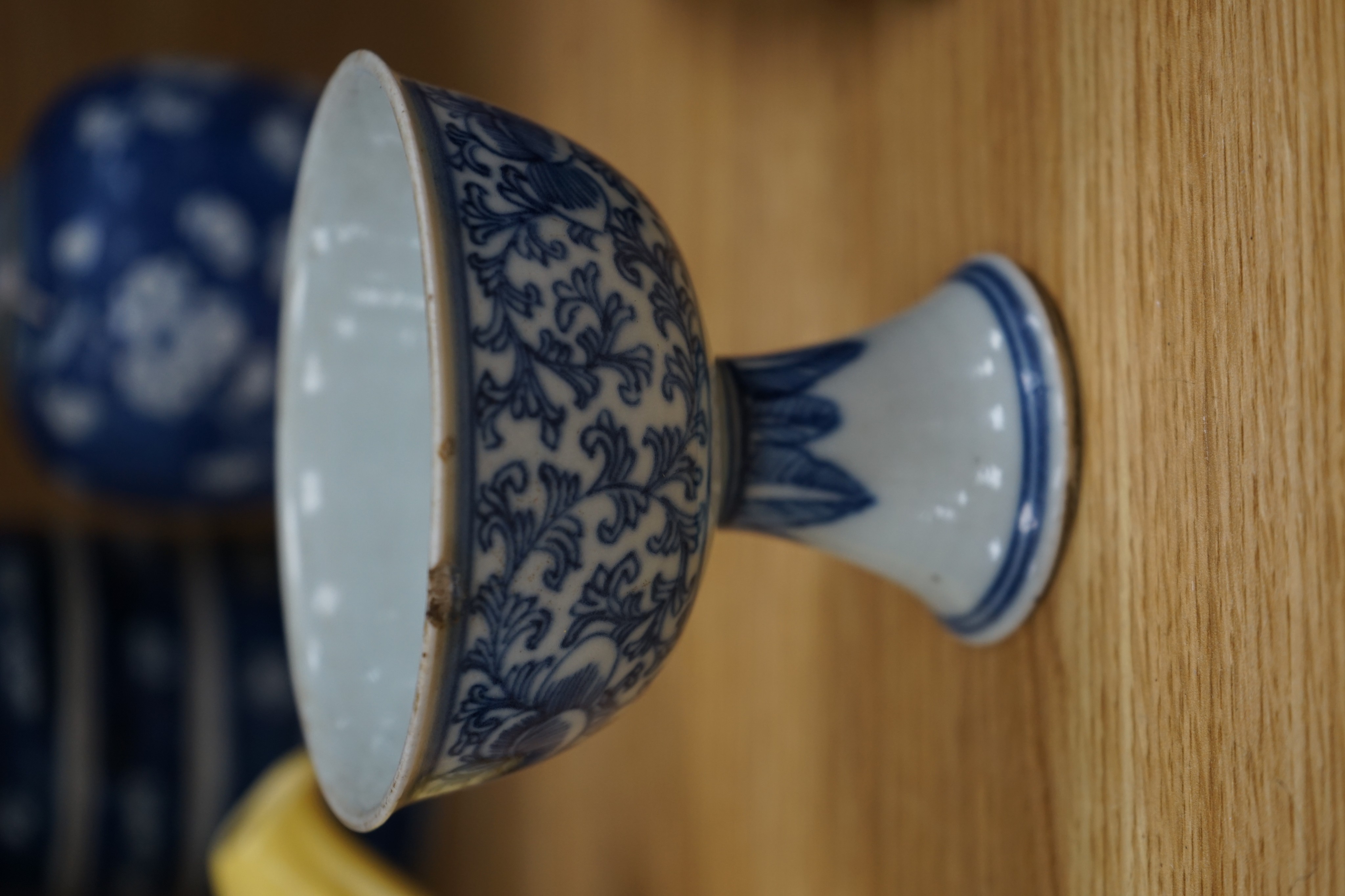 A Chinese blue and white ovoid jar and cover and similar stacking box, Kangxi and a Qing blue and white footed cup, tallest 15cm